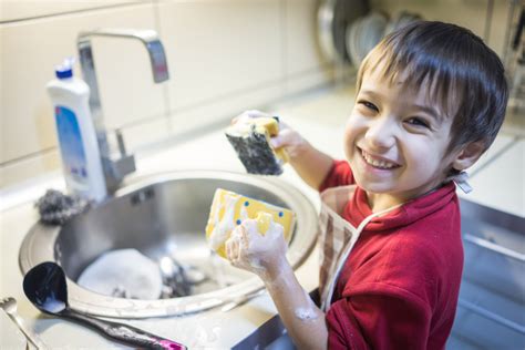 A Child Washing Dishes Ladybug Child Care Center