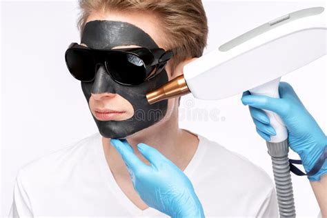 Beautician Doing Carbon Peeling Procedure To Handsome Guy In Beauty