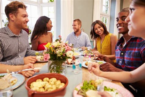 Male Friends At Home Sitting Around Table For Dinner Party Stock Image