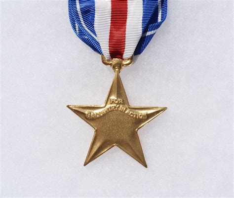 A Gold Medal With A Red White And Blue Ribbon Around Its Neck