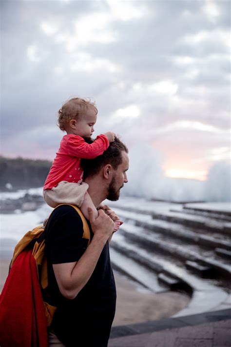 Father Carrying His Child On His Shoulder · Free Stock Photo