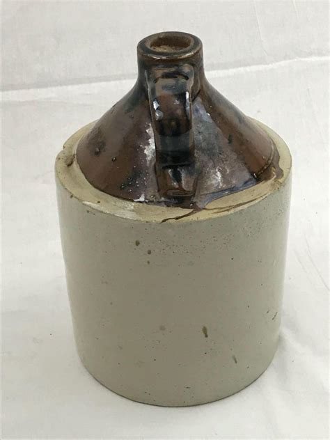 The word moonshine is just to suggest that the drink is a very strong alcoholic drink. Antique Pottery Crock Moonshine Jug