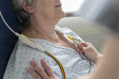 A Nurse Places Electrodes On A Patients Chest Stock Photo