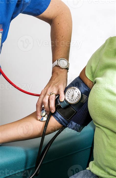 Female Clinician In The Process Of Conducting A Blood Pressure