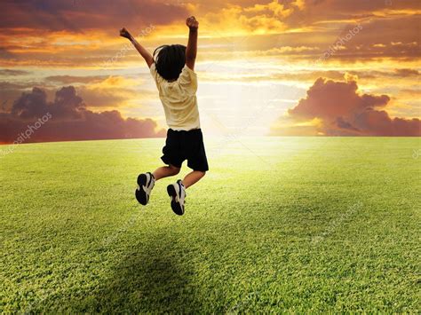 Happy Child Jumping On A Green Meadow — Stock Photo © Zurijeta 6151000