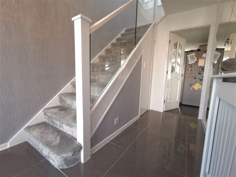 Luxury wide glass staircase with satin glass treads and clear glass railing. White Staircase, Embedded Glass - Edwards & Hampson