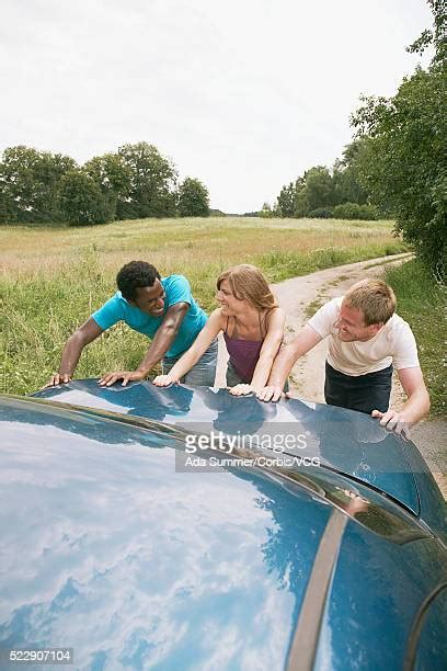 Group Of People Pushing Cars Photos And Premium High Res Pictures