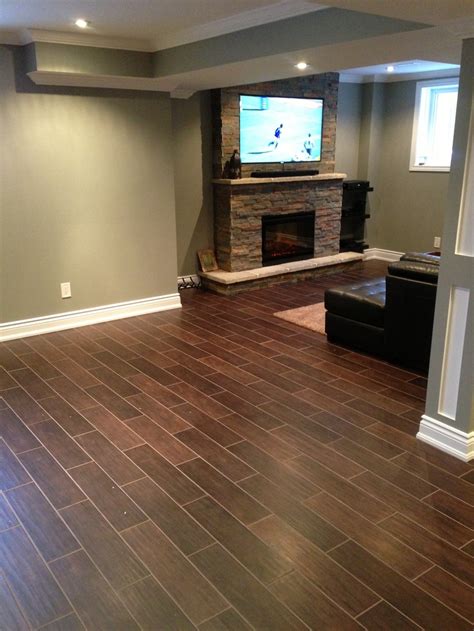 Luxury vinyl plank can work with radiant heat installed in your concrete basement. Hardwood floor alternative. Hardwood styled tile dark ...