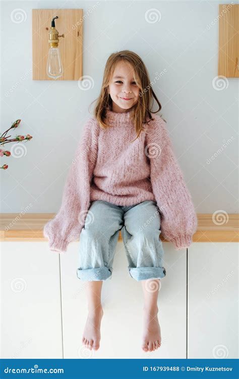 Little Barefoot Girl Is Reaching For Camera With Her Hands Obstructing