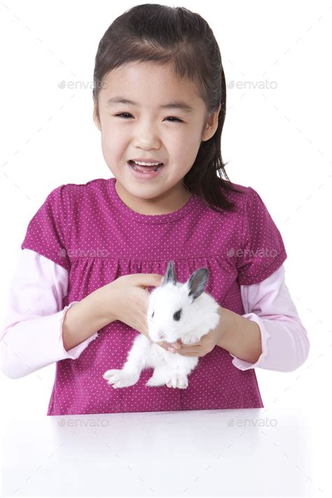 Little Girl Playing With Rabbit Stock Photo By Bluejeanimages Photodune