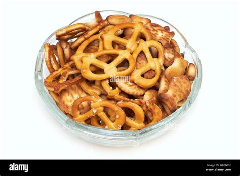 Mix Of Salty Snacks Crackers And Pretzels In Glass Bowl Isolated On