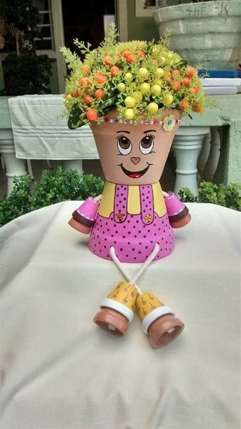 A Flower Pot Sitting On Top Of A Table Covered In Yellow And Orange