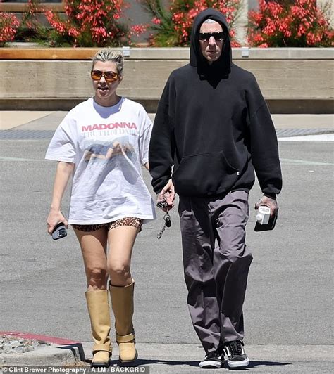 kourtney kardashian holds hands with husband travis barker as they enjoy an outing in palm