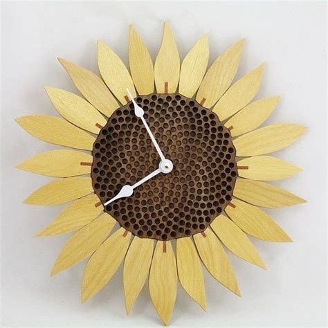 A Clock Made Out Of Honeycombs With A Sunflower On The Front And Side