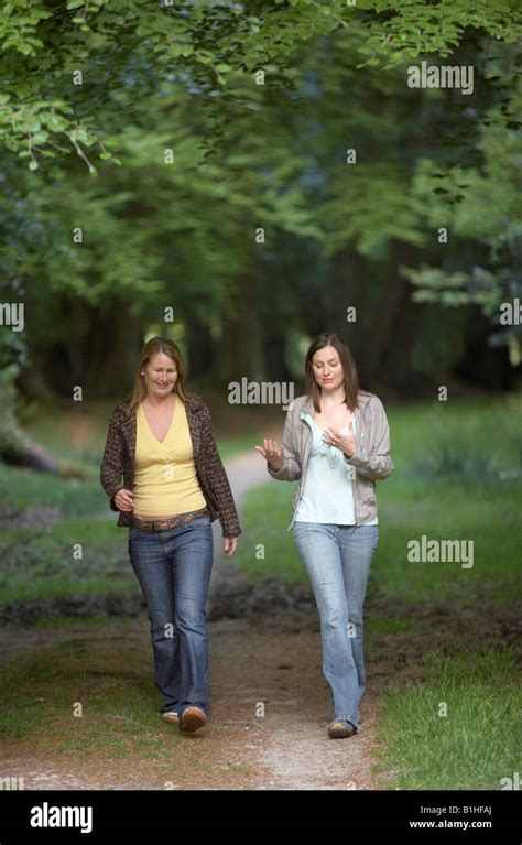 Two Young Women Walking Through Woods Stock Photo Alamy