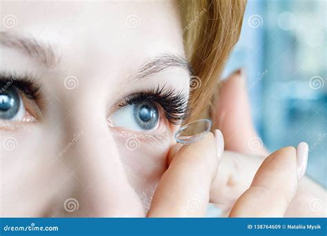 A Closeup Of A Woman Inserting A Contact Lens Into Her Eye Stock Image Image Of Correction