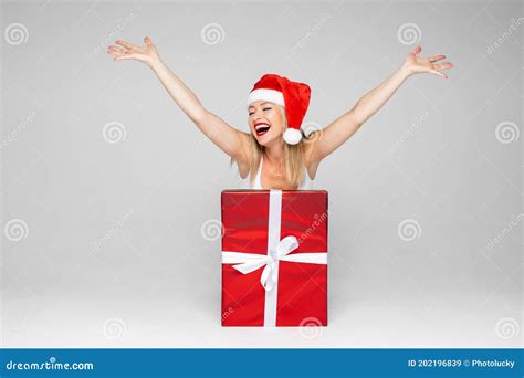 Happy Woman Bursting Out Of A Fancy Christmas Present Stock Image