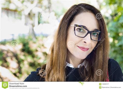 Portrait Of A Mature Woman Wearing Eyeglasses Outdoors