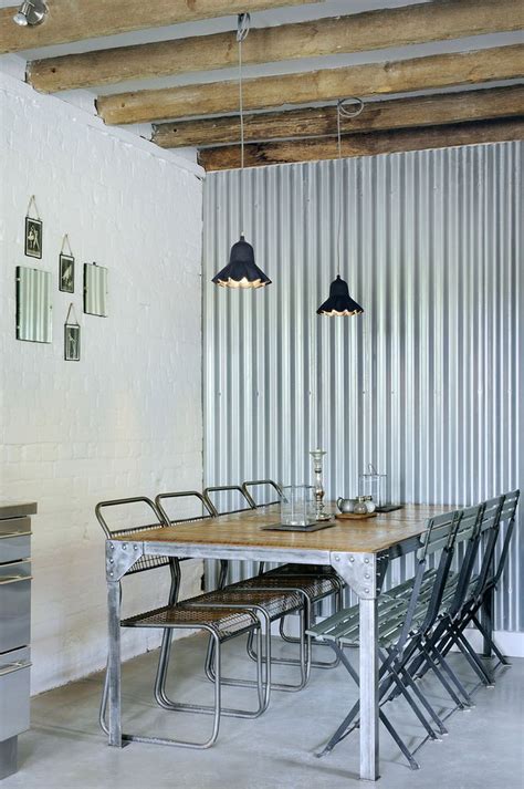 A Dining Room Table And Chairs In Front Of A Wall With Vertical Striped
