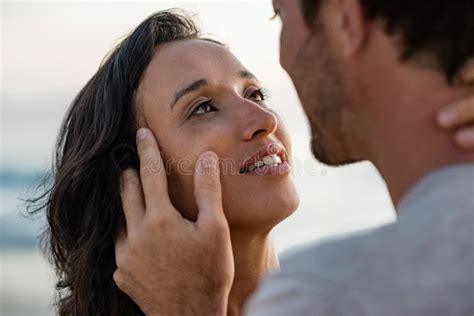 Loving Woman Staring Into Her Husband S Eyes At The Beach Stock Photo