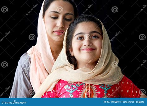 Portrait Of Adorable Smiling Pakistani Muslim Girl With Beautiful Eyes And Her Mother Wearing
