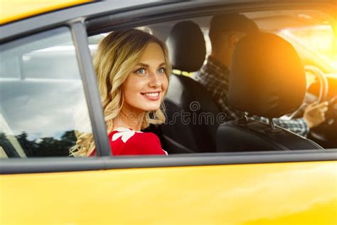 Photo Of Happy Woman Sitting In Back Seat Of Yellow Taxi In Summer