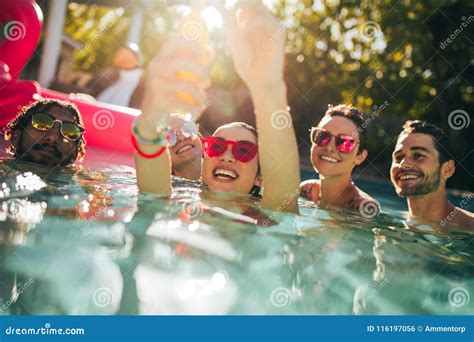 Multiracial Group Of Friends Having Fun In A Pool Stock Photo Image