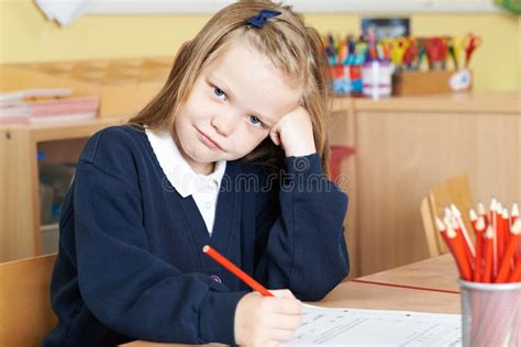 Bored Female Elementary School Pupil At Desk Stock Image Image Of