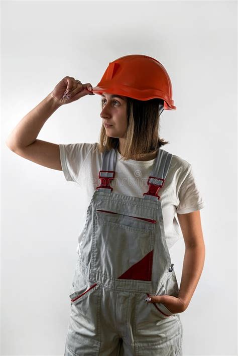 Young Female Architect Builder Posing In Uniform And Helmet Smiling