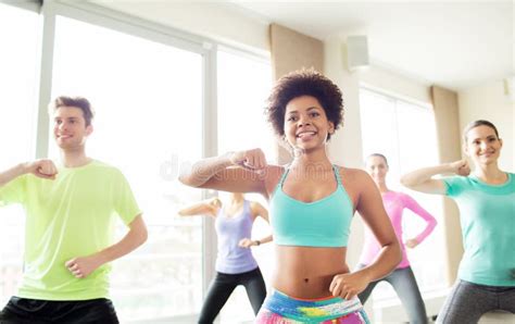 Group Of Happy People Exercising Or Dancing In Gym Stock Photo Image