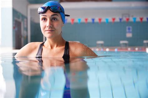 Female Swimmer Wearing Goggles Training In Swimming Pool Stock Image