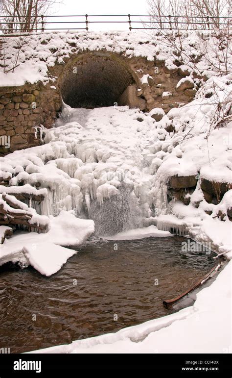Stream Water Flow Through Arch Waterfall Ice Icycles Frozen In Winter