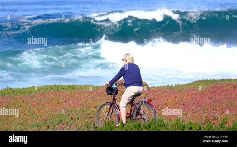 Retired Woman Riding On Beach Stock Photo Alamy