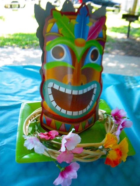 Tiki Masks Centerpieces With Flowers Tiki Torches And Hula Skirts As