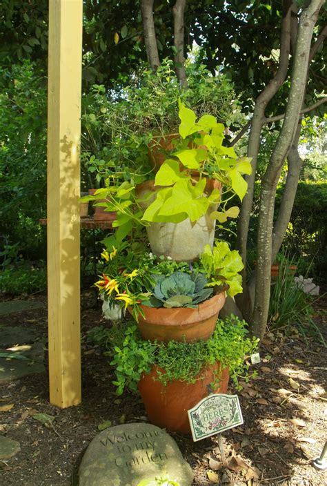 Heads Up Herbs Thrive In Tipsy Terra Cotta Tower Garden Containers