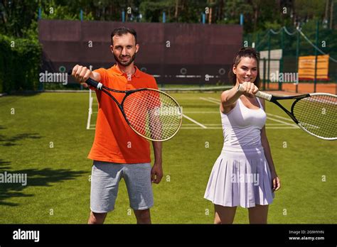 Two Tennis Players Practicing A Correct Grip Technique Stock Photo Alamy