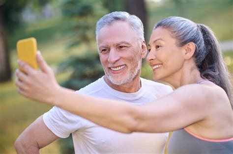Premium Photo A Mature Happy Couple Making Selfie And Looking Contented