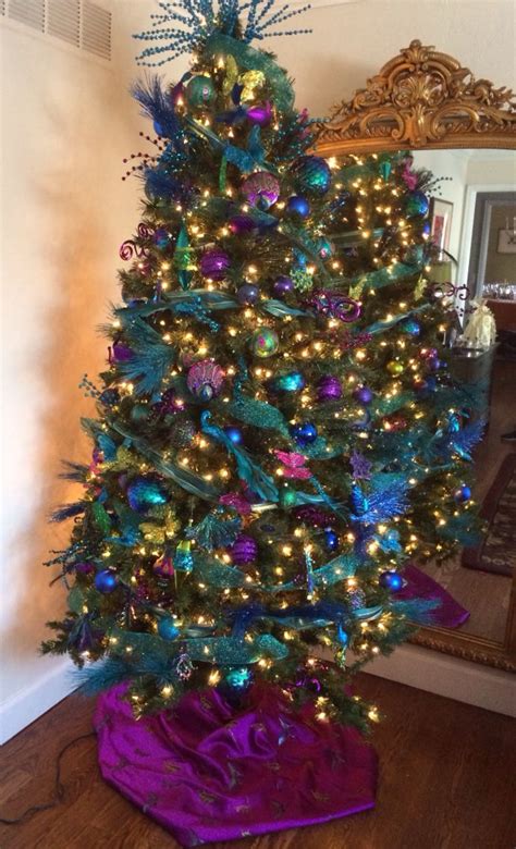 Peacock feathers are green, brown, gold, light blue, and navy. Peacock themed Christmas tree. | Peacock christmas ...