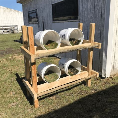 Three White Buckets Are Stacked On A Wooden Rack
