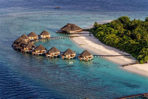 Maldives A Beach Scene From Meedhupparu In The Maldives Water Huts