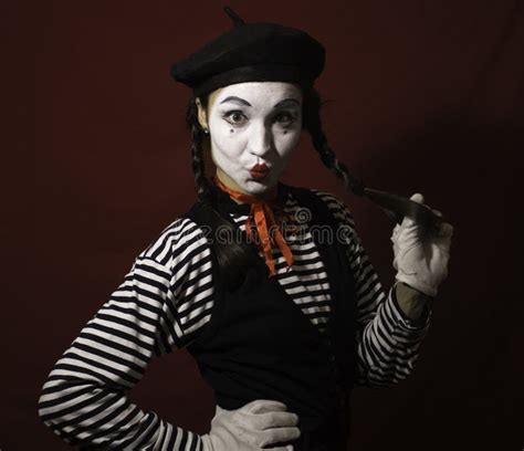 Beautiful Mime Girl Grimaces And Shows A Victory Sign With Her Hand