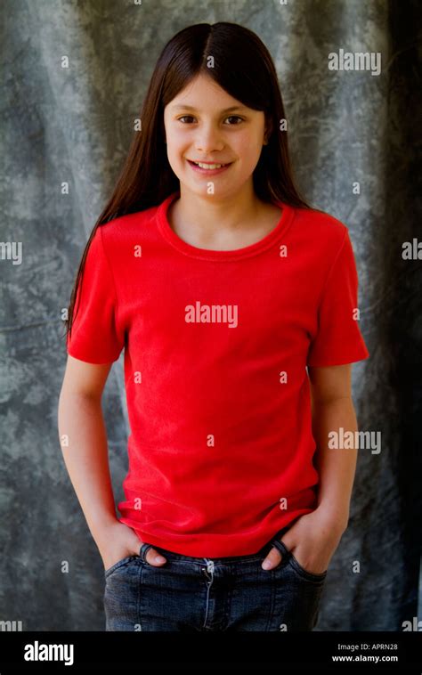 Happy Young Pre Teen Girl In Red T Shirt On Grey Background Looking To