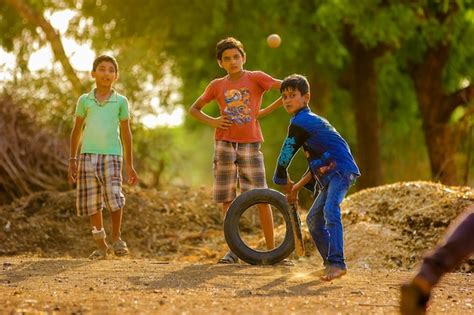 Premium Photo Rural Indian Child Playing Cricket On Ground