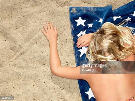 Girl Lying On Beach Photos And Premium High Res Pictures Getty Images