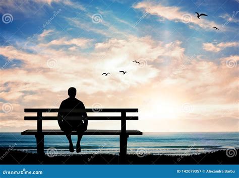 Man Silhouette Sitting Alone On The Bench At Sunset And Thinking Stock