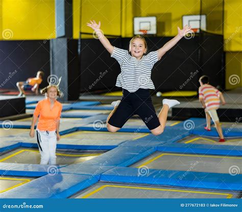 Tween Girl Bouncing On Trampoline In Indoor Amusement Park Stock Image