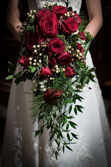 Cascading Bouquet Of Red Roses White Berries The Greenery Is A Mix Of