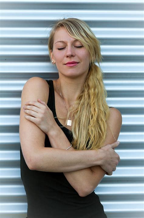 Portrait Of Young Beautiful Blonde Woman Closing Her Eyes With Steel