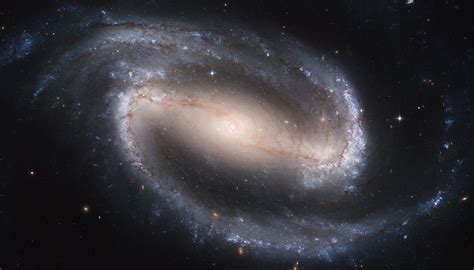 Barred Spiral Galaxy Ngc 2608 Surrounded By Many Many Other Galaxies