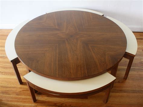 An antique rustic table and white modern chairs plus a bench for a cozy dining space. Mid century modern round game coffee table with 4 hidden ...